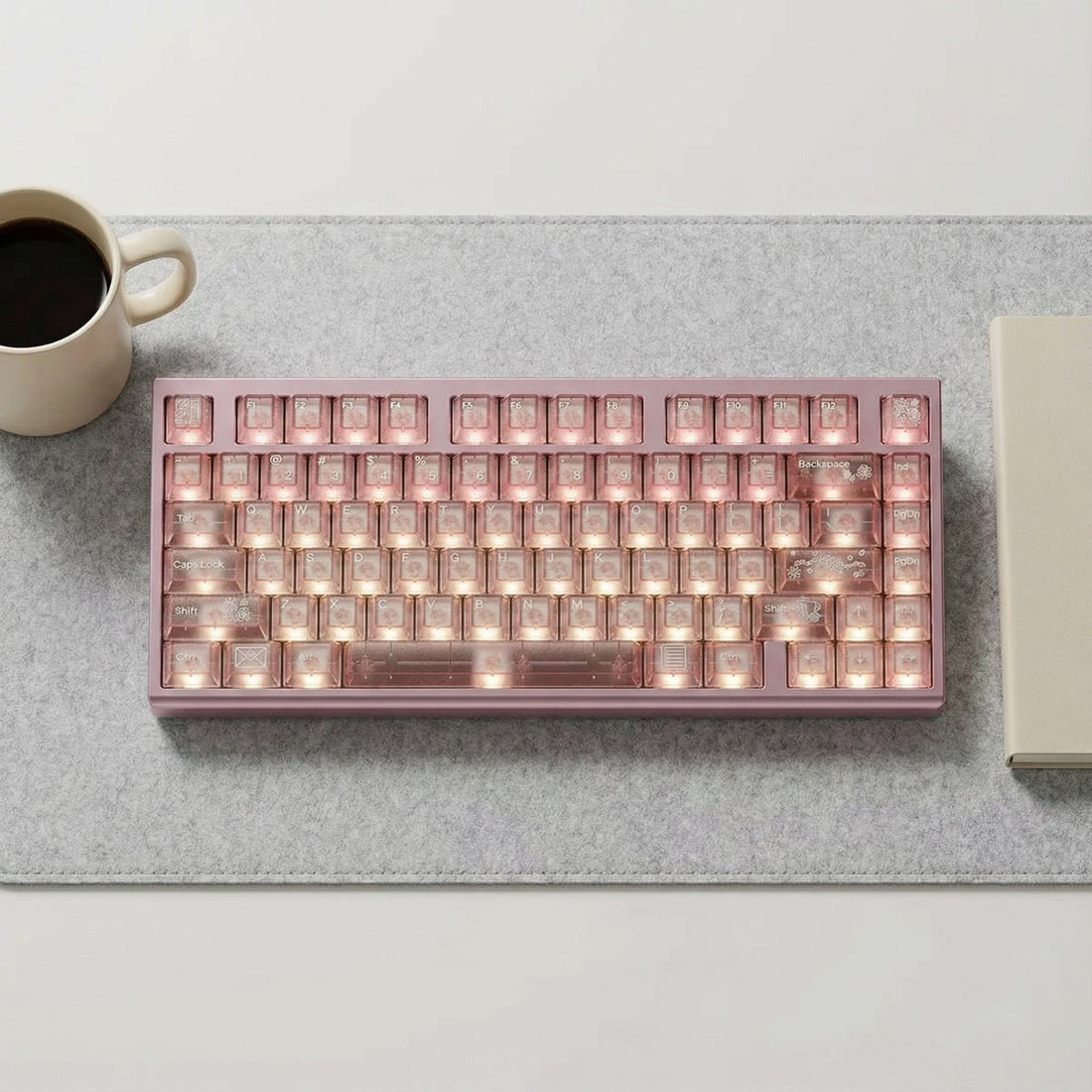 A clean desk setup featuring a budget mechanical keyboard with RGB lighting and a wooden wrist rest.